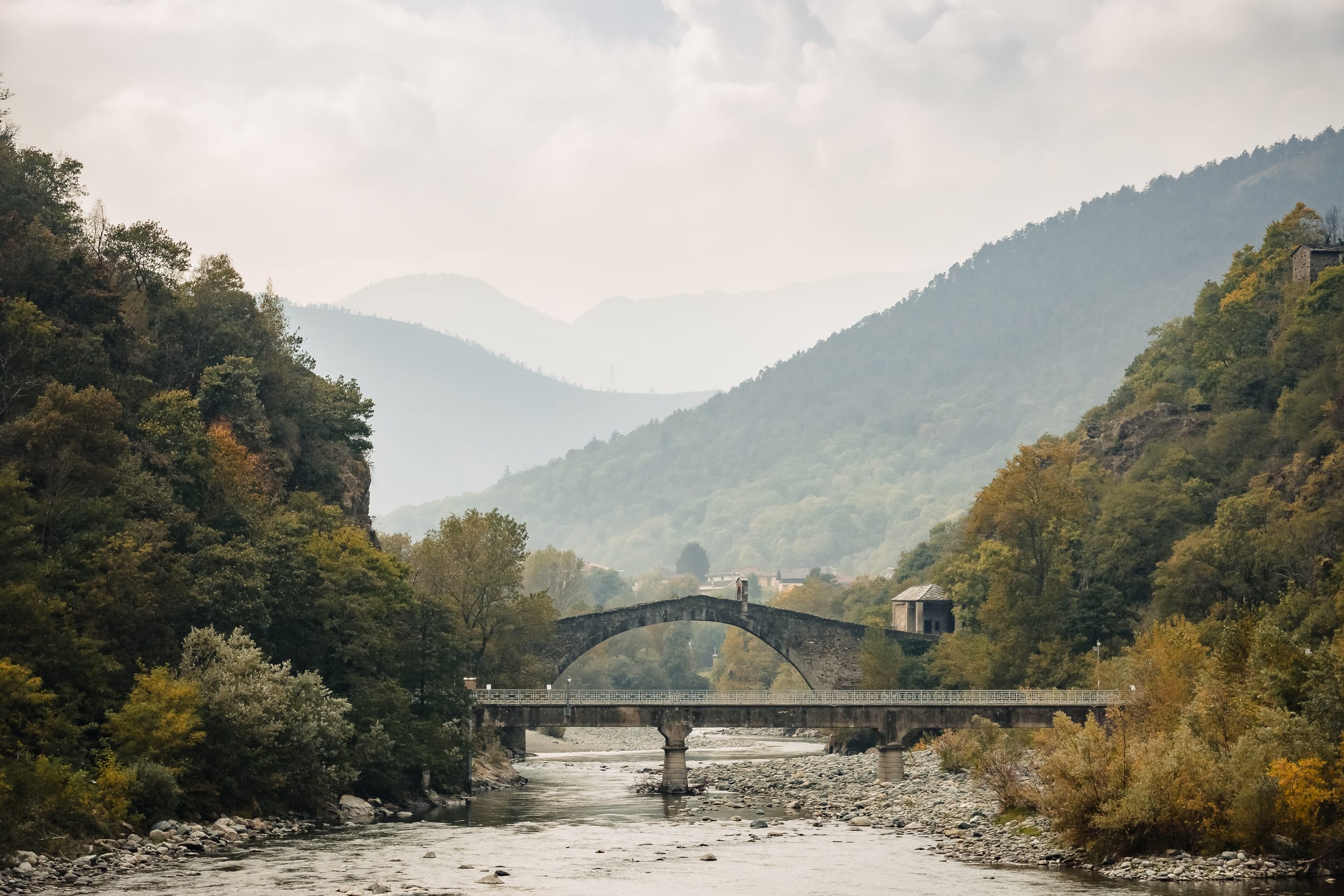 Blick ins Tal Alte Brücke über Fluss im Piemont